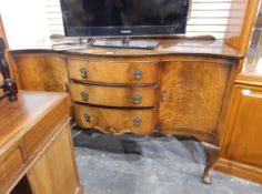 A modern veneered serpentine-fronted sideboard on cabriole shaped legs with pad feet,