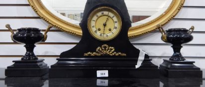 A Victorian black slate clock garniture, the drum-shaped movement in waisted case, on plinth base,