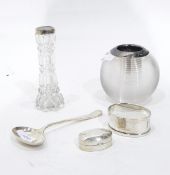 A silver napkin ring of oval form, engraved with the initial 