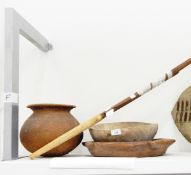 A tribal earthenware pot of globular form with flared rim, two wooden bowls,