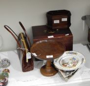 A turned oak mahogany stand with dished top on circular foot, a desk tidy,