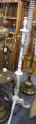 Two white painted carved wooden standard lamps (one lacking its fitting) (2)