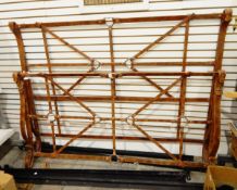 An iron and simulated leather strapwork double bed,