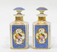 A pair of continental porcelain scent flasks and stoppers of square form,