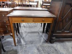 An Edwardian writing table with inset leatherette to frieze,