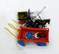 A Britains painted lead model of a cart, another cart model and associated carthorses, etc.