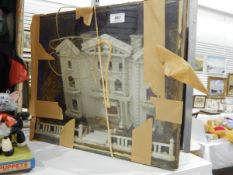 A diorama of a white three-gabled house, in glazed case,