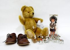 A vintage plush teddy bear with glass eyes,