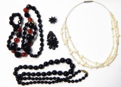 String of faceted French jet and cornelian graduated beads, another string French jet beads,