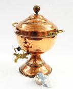Copper hot water urn with brass handle and tap, on flared circular base,