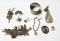 Silver curb link charm bracelet hung with multiple silver charms including a compass, a flask, etc.