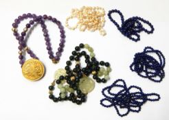 Three lapis bead necklaces, jade bead and pierced disc necklace,