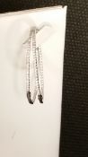 Pair of 18ct white gold and diamond oval hoop earrings, with claw set diamonds to the front edge,