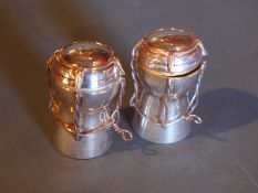 A pair of Asprey hallmarked silver jubilee year Champagne cork form salt and pepper shakers,
