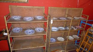 A pair of 20th century bamboo open bookcases with bergere backing.