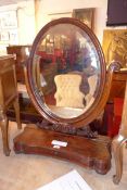 A 19th century frame mahogany toilet mirror with oval bevelled plate and lifting jewellery