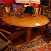 A Borge Mogensen style Danish oak drop leaf table of circular form.
