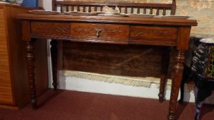 A Victorian oak side table with gallery back and fitted single drawer raised on turned supports.