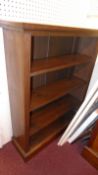 A 19th century oak open bookcase with adjustable shelves on a plinth base.