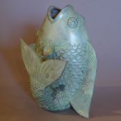 A Chinese bronze vase in the form of a breaching fish.