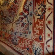 A Persian style carpet with foliate decoration.