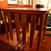 A retro teak nest of four occasional tables within single rectangular table.