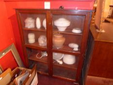 An early 20th century mahogany bookcase fitted pair of glazed panel doors enclosing shelves on