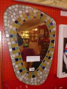 An Italian 1950's wall mirror with mosaic frame and brass binding.
