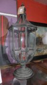 A wrought metal garden lantern having internal glass tea light holders.