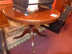 A Victorian mahogany breakfast table the circular top raised on turned column and quadruple