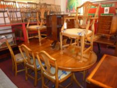A set of eight Hepplewhite style dining chairs with wheatsheaf splat backs above drop in seats on