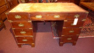 A 20th century mahogany campaign pedestal desk with brass binding and inset brass handles to the
