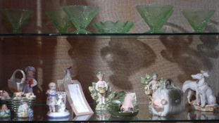 A collection of Continental porcelain figures and green pressed glass sundae dishes.
