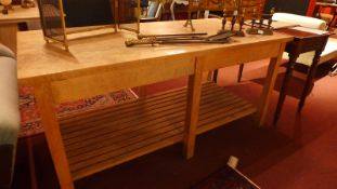 A vintage maple work table the rectangular plank top raised on six limed oak square section