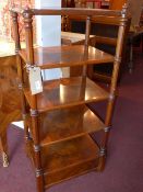 A Victorian walnut whatnot of five tiers, terminating on faceted columns.