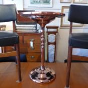 A copper clad oak occasional table with circular top.