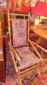 An American rocking chair upholstered in Persian style geometric fabric and raised on turned