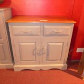 A grey painted side cabinet fitted two drawers and pair of panelled doors on plinth base.