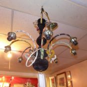 A vintage eight branch chandelier clad in various fabrics.