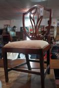 A set of four Hepplewhite design mahogany dining chairs with pierced splat backs and drop in seats