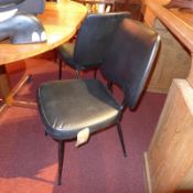 A pair of retro 1960's side chairs upholstered in black faux leather on black painted supports.
