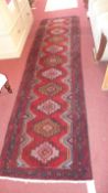 A fine north west Persian Hamadan runner 303cm x 85cm repeating stylised geometrical motifs on a