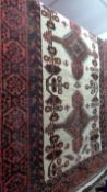 A fine north east Persian Mashad Belouch rug 210cm x 105cm a row of stylised medallion with