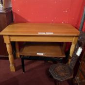 A 20th century light oak side table , the rectangular top raised on turned supports.