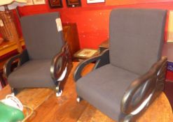 A pair of contemporary childs chairs upholstered in black fabric and raised on painted elephant