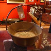 A 19th century brass preserve pan with a cast iron handle.