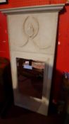 A 20th century grey painted pier mirror with floral sway detail in relief and rectangular bevelled