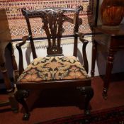 A 19th century Chippendale style carved mahogany armchair with pierced splat back and drop in seat