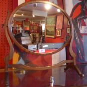 A 19th century mahogany swing frame toilet mirror with oval plate.