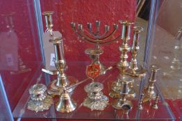 Ten various pairs of brass candlesticks including antique examples, a Minora and a candle snuff.